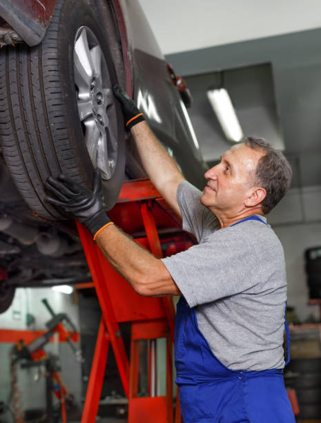 istock Technician working at service station, repairing car 1223294546