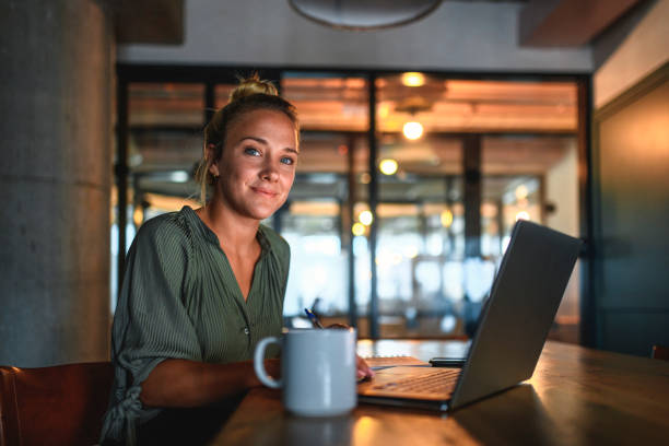 istock Contented Young Businesswoman Using Laptop in Board Room 1223296042