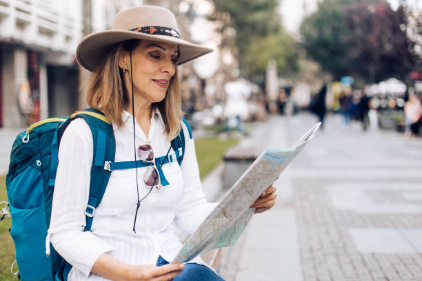 istock Lady sitting on the bench and holding the map 1223296072
