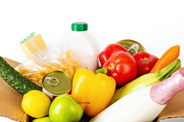 istock Donation box with various smart food on white background with copy space. Mockup. Food donations or food delivery service concept. Online shopping during coronavirus covid-19 lockdown 1223301941
