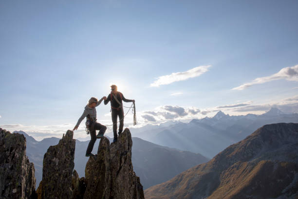 istock Mountaineers climb up rock pinnacle 1223302823