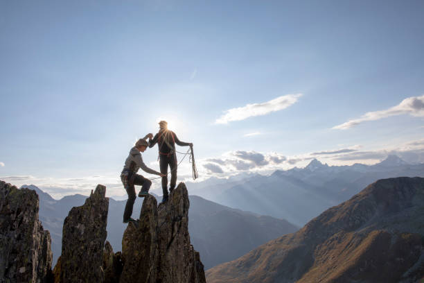 istock Mountaineers climb up rock pinnacle 1223303041