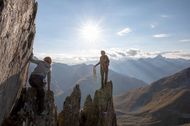 istock Mountaineers climb up rock pinnacle 1223304561