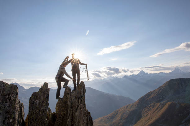 istock Mountaineers climb up rock pinnacle 1223305028