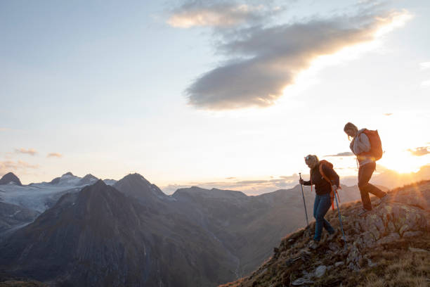 istock Female hikers walk along footpath at sunset 1223307371