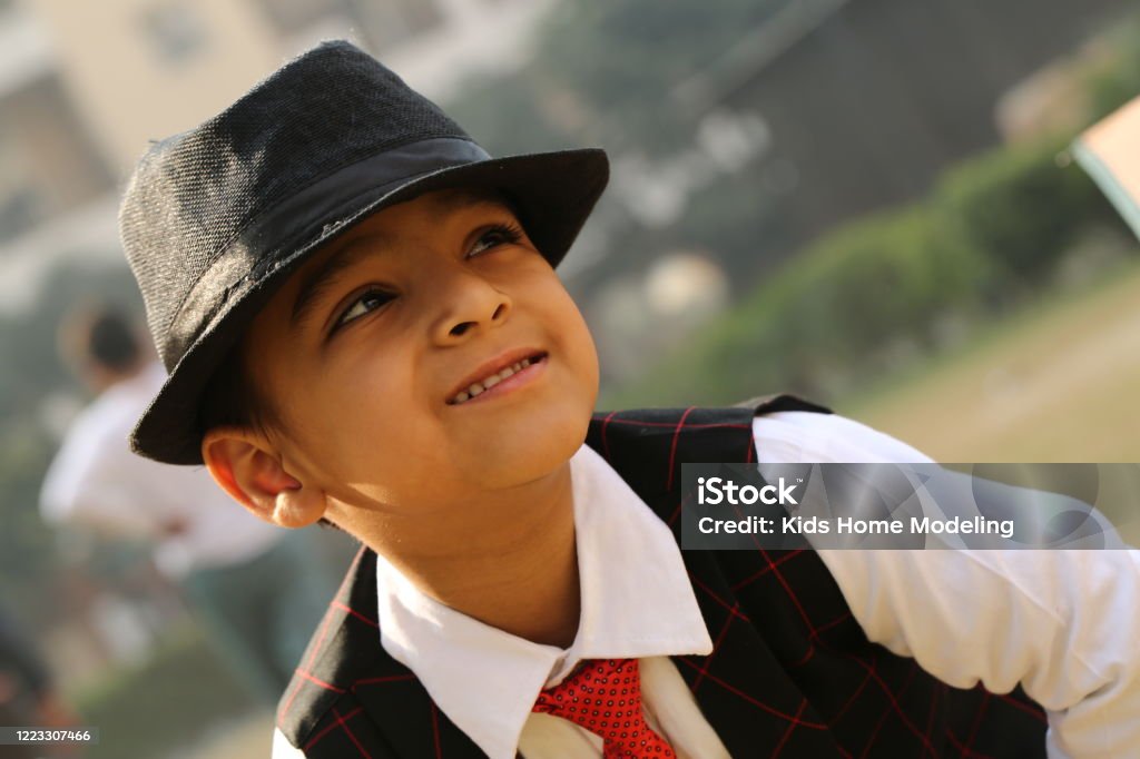 Stylish Young Boy in India Plays Outdoors in his Yard. A very cute young kid in India is enjoying the outdoors, posing in various assorted garments and playful activities. Why not enjoy the day with him, as this handsome young man strives to make the most of this beautiful day?! 4-5 Years Stock Photo Stylish Young Boy in India Plays Outdoors in his Yard. A very cute young kid in India is enjoying the outdoors, posing in various assorted garments and playful activities. Why not enjoy the day with him, as this handsome young man strives to make the most of this beautiful day?! 4-5 Years Stock Photo