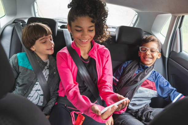 istock Children watching video while traveling by car 1223308247