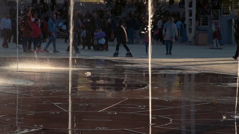 Children playing around the fountains public park