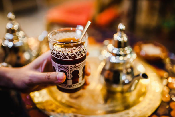 istock hands with traditional Arabic tea cup, arab people drinking tea in Ramadan 1223316006