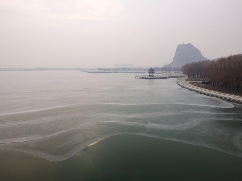 Frozen lake at Wang'er Mountain, located east of Xiongyue Town, Yingkou City, height 82 meters. There is a Tibetan-style green brick pagoda on the top of the mountain, named Wanger Pagoda, built in the late Ming and early Qing Dynasties. Wangershan is listed in the Dictionary of Chinese Scenic Spots, Liaoning, China.