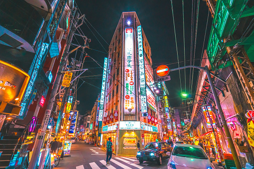 Tokyo rush hour commuters neon night streets of Shimbashi Japan