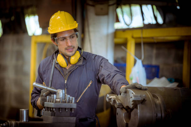 istock The Industry engineering and teamwork wearing safety uniform control operating lathe grinding machine working in industry factory. 1223320947