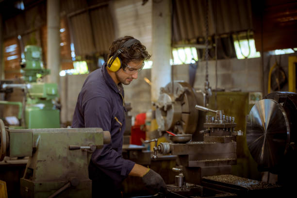 istock The Industry engineering and teamwork wearing safety uniform control operating lathe grinding machine working in industry factory. 1223322591