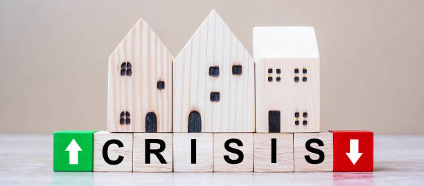 istock CRISIS cube blocks with wooden house model on table background. Coronavirus pandemic, fall Business, unemployment, Economic recession, Developer, Real Estate and Property concept 1223324567