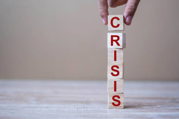 istock wooden cube blocks with CRISIS text on table background. Coronavirus pandemic, risk, fall Business, unemployment, Economic recession and Bankrupt concept 1223324619