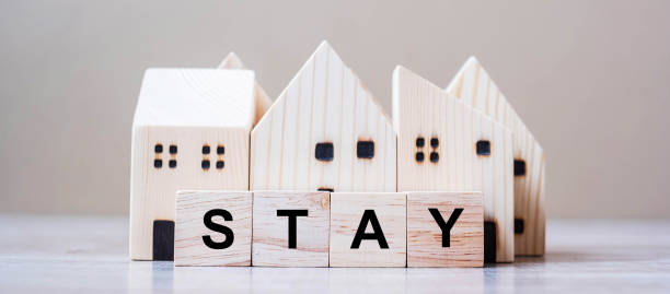 istock Wooden Cube blocks with STAY text and Home model on table background. Coronavirus, Covid-19, Quarantines and Social Distancing concept 1223324622