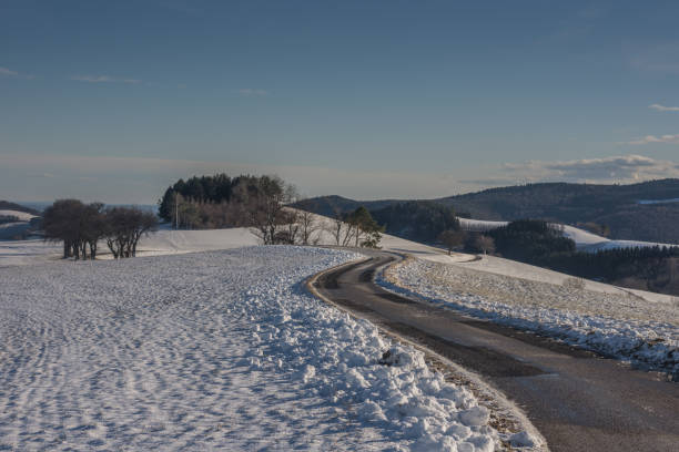 istock road with curves and snowy landscape 1223330698