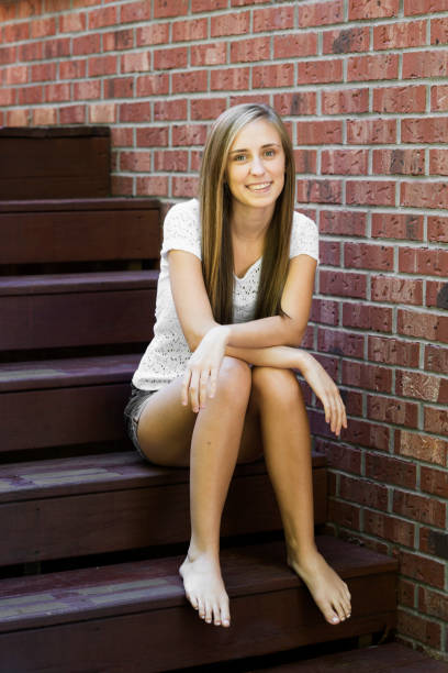 Close up shot of an unhappy looking young woman in front of an old building