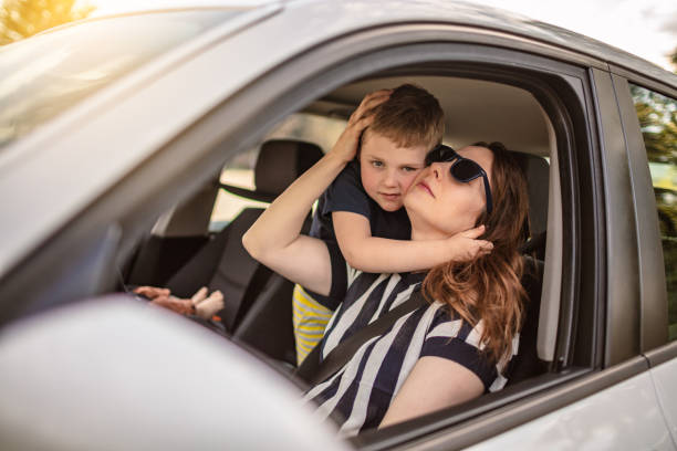 istock Woman in Car with Little Boy 1223330975