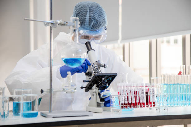 istock Scientist in laboratory with test tubes 1223331848
