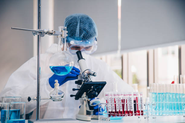 istock Scientist in laboratory with test tubes 1223331887