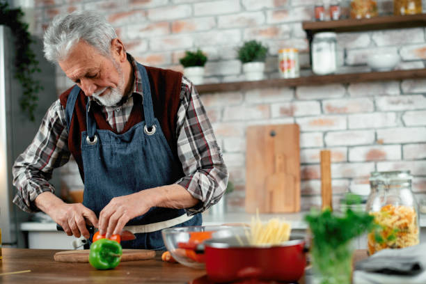 istock Senior man cooking delicious food in kitchen. 1223334814