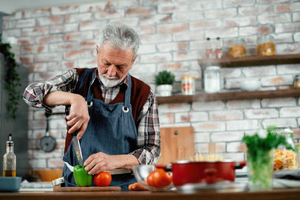 istock Senior man cooking delicious food in kitchen. 1223334861