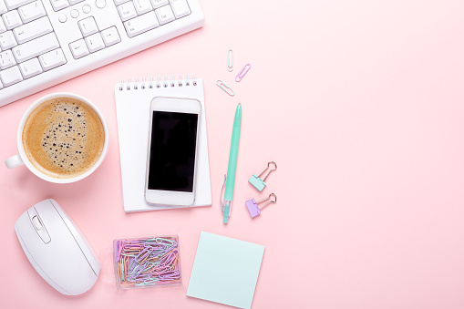 Fashion blogger workplace with cup of coffee and smartphone on pink background, flat lay, top view - Image