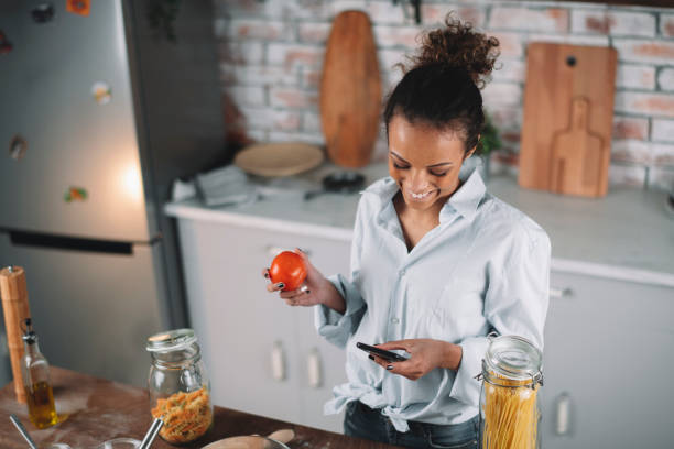 istock Beautiful woman preparing food in kitchen. 1223337484