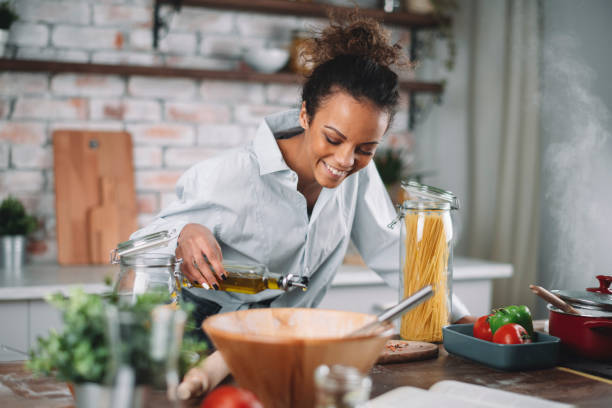 istock Beautiful woman preparing food in kitchen. 1223337540