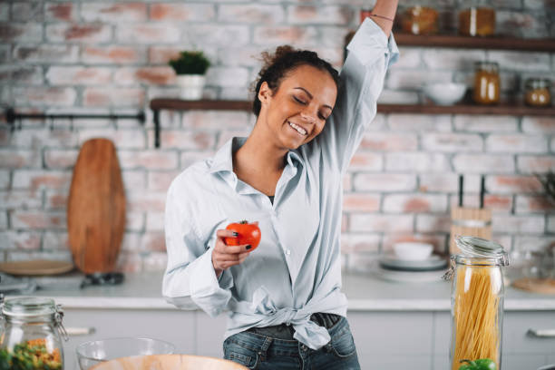 istock Beautiful woman preparing food in kitchen. 1223337587