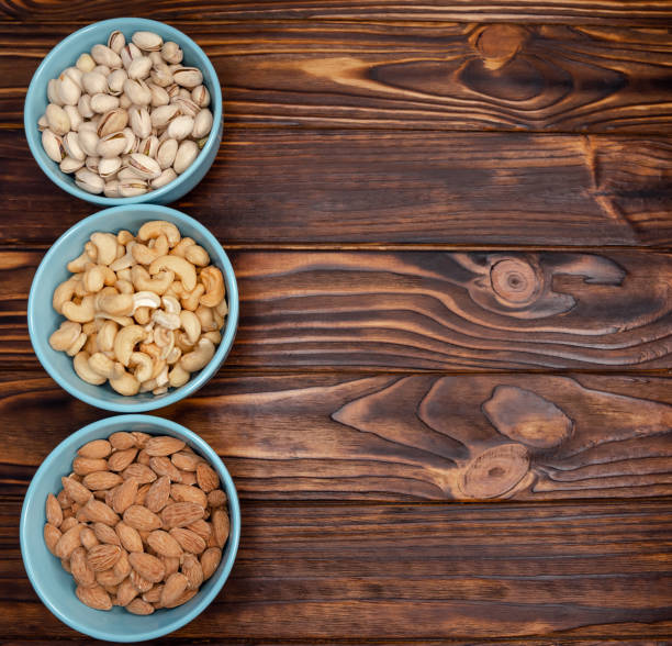 istock Different types of nuts in bowls. Almonds, pistachios, cashews Flatly 1223338204
