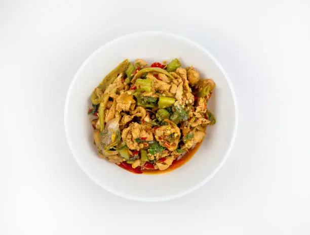 Photo of Stir-fried chicken with holy basil on white background., hot and spicy food