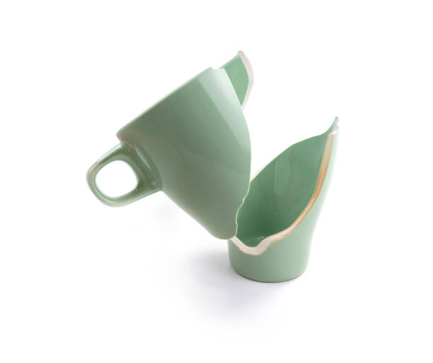 Broken coffee mug on white background, broken cup pieces, Broken relationship and Parting concept