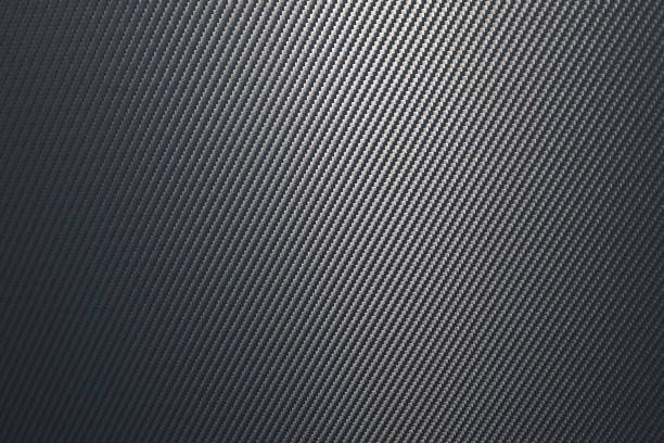 istock Close up of grey diagonal oriented woven carbon fibre sheet surface. 1223340138