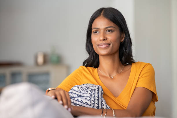 istock Smiling indian girl relaxing at home 1223342921