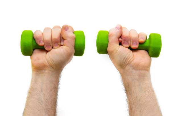 istock Male both arms raised up with a green dumbbells. 1223347705