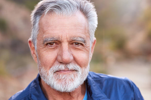 outdoor portrait of serious hispanic senior man with mental health concerns - portrait men senior adult depression imagens e fotografias de stock