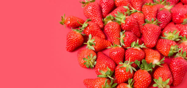 istock Ripe juicy orgaic strawberries on a red background. 1223349703