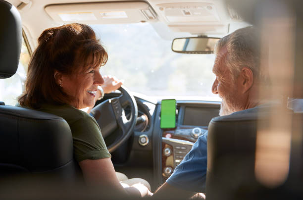 istock Senior Hispanic Couple On Drive Through Countryside Using Sat Nav On Mobile Phone 1223351341