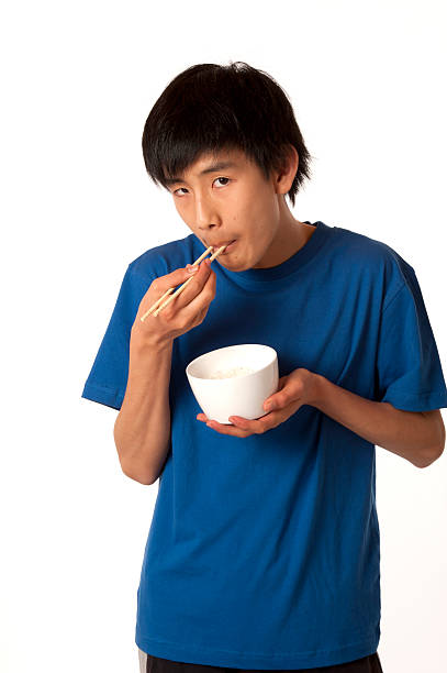 istock Asian Chinese boy eating rice with chopsticks 122335283