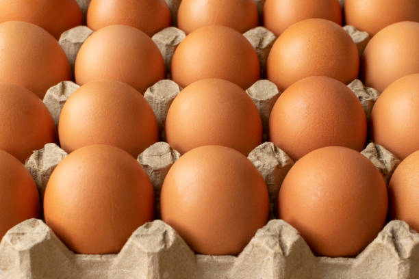 istock Brown egg in paper packaging. Container for eggs. Recycling. Healthy rustic breakfast 1223353059