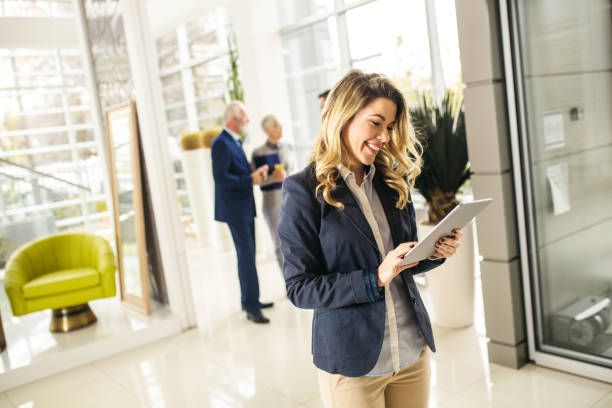 istock Young manager standing in front of colleagues with digital tablet 1223356320