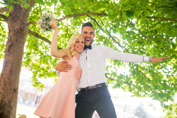 Cheerful Bride and Bridegroom Outdoors in Public Park