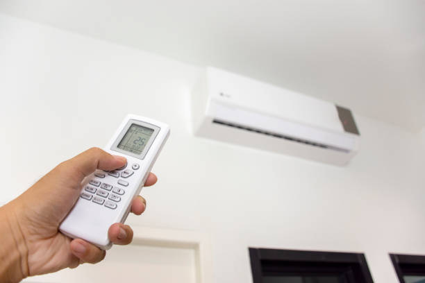 istock Hand is using white remote of air conditioner. 1223357177