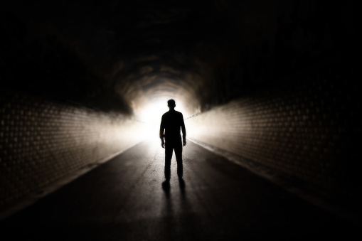 Stockholm, Sweden A man walks through a pedestrian and bicycle tunnel at night.