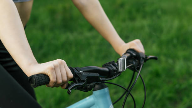 istock Young woman holds bicycle handlebar 1223361255