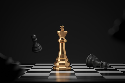 A single golden figure of a businessman walking at chessboard board to the group of black chess pieces with a giant king piece in the middle. Leadership, business strategy, career, the way forward concepts