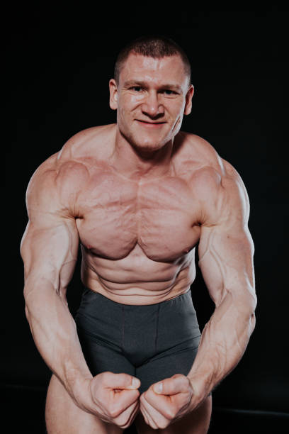 istock Sport the athlete bodybuilder shows off his muscles 1223365639
