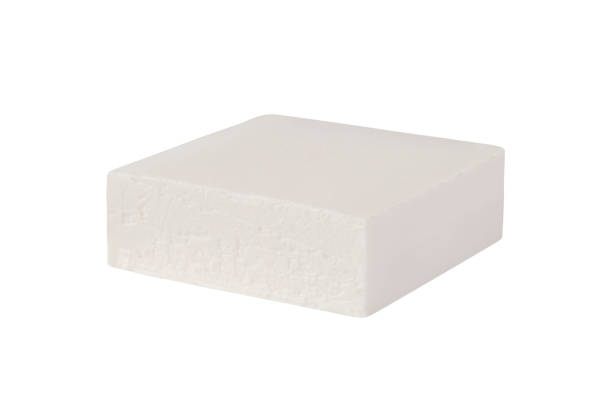 Cheese feta or bryndza Block of brined curd white cheese feta or bryndza isolated on white background feta cheese block stock pictures, royalty-free photos & images